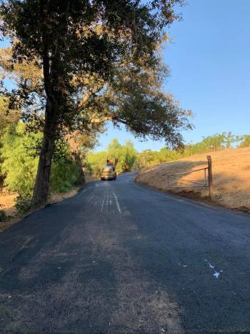 Roller smoothing out new asphalt on driveway