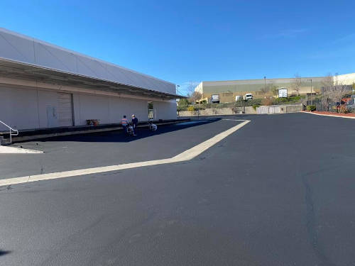 Commercial parking lot with new sealcoating done in Phoenix, AZ